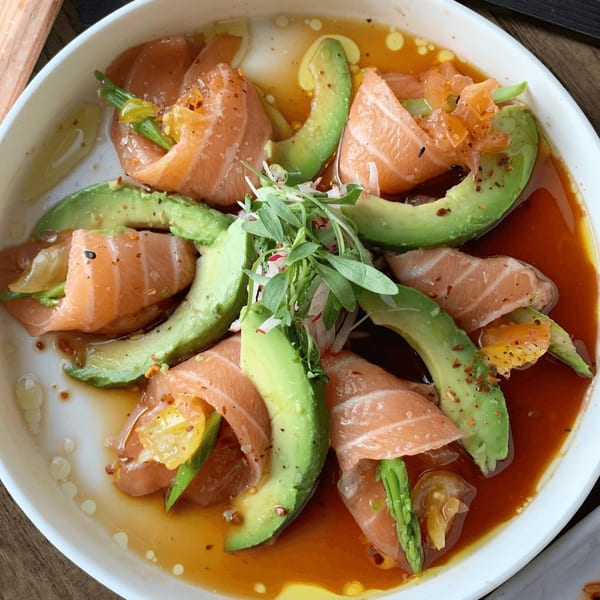 E+O Kitchen's salmon and avocado salad with greens and a savory dressing.