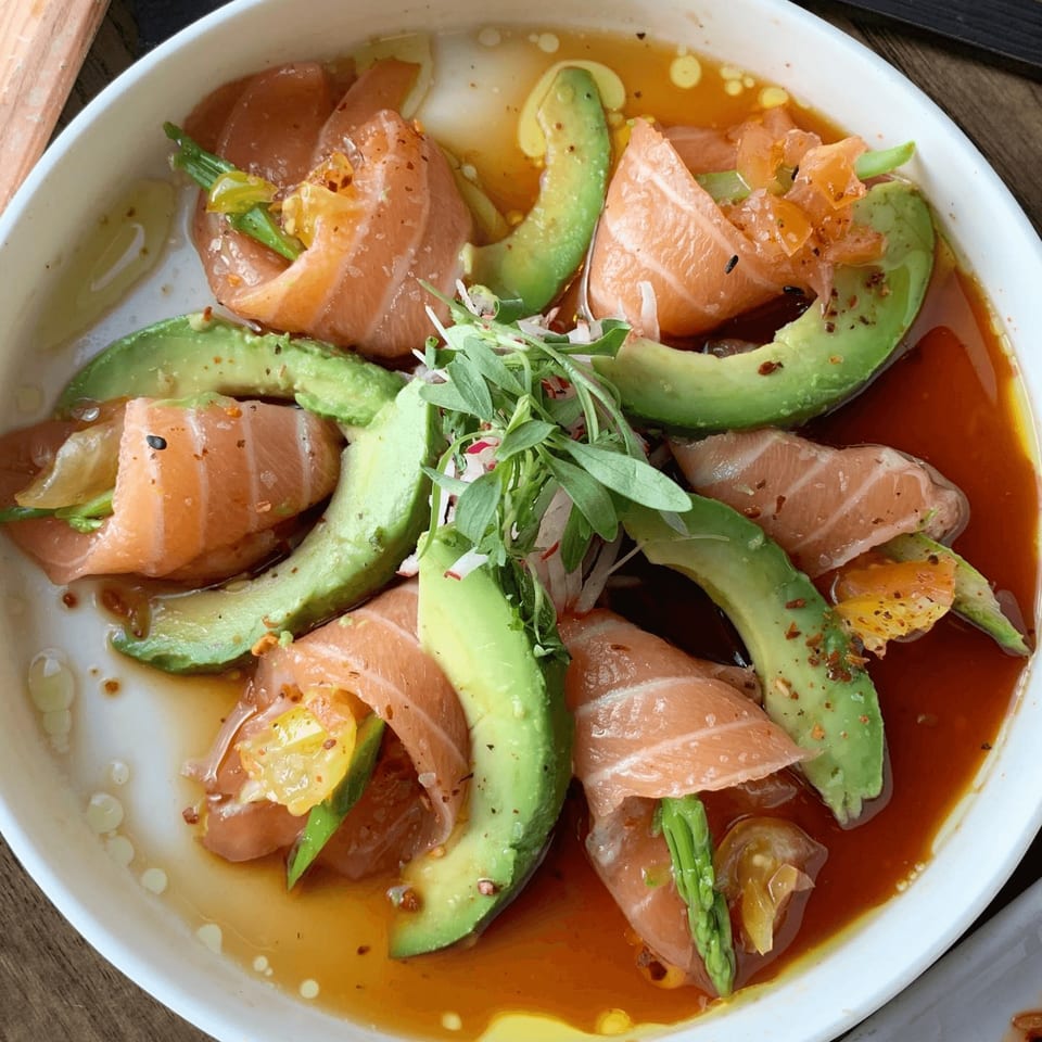 E+O Kitchen's salmon and avocado salad with greens and a savory dressing.